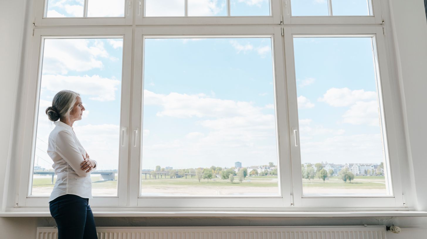 A woman looking out uPVC windows
